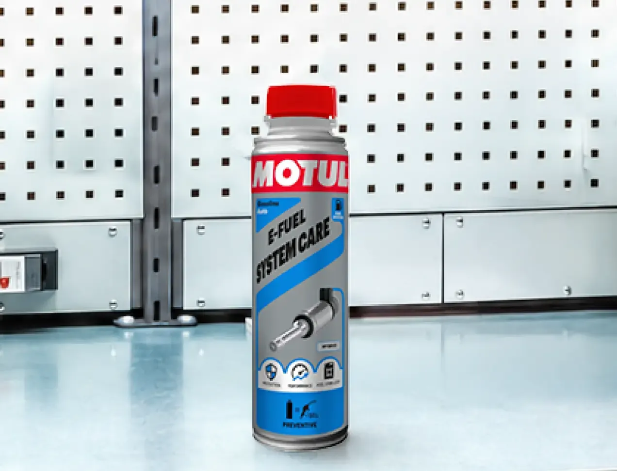Motul e-Fuel System Care bottle in a workshop setting