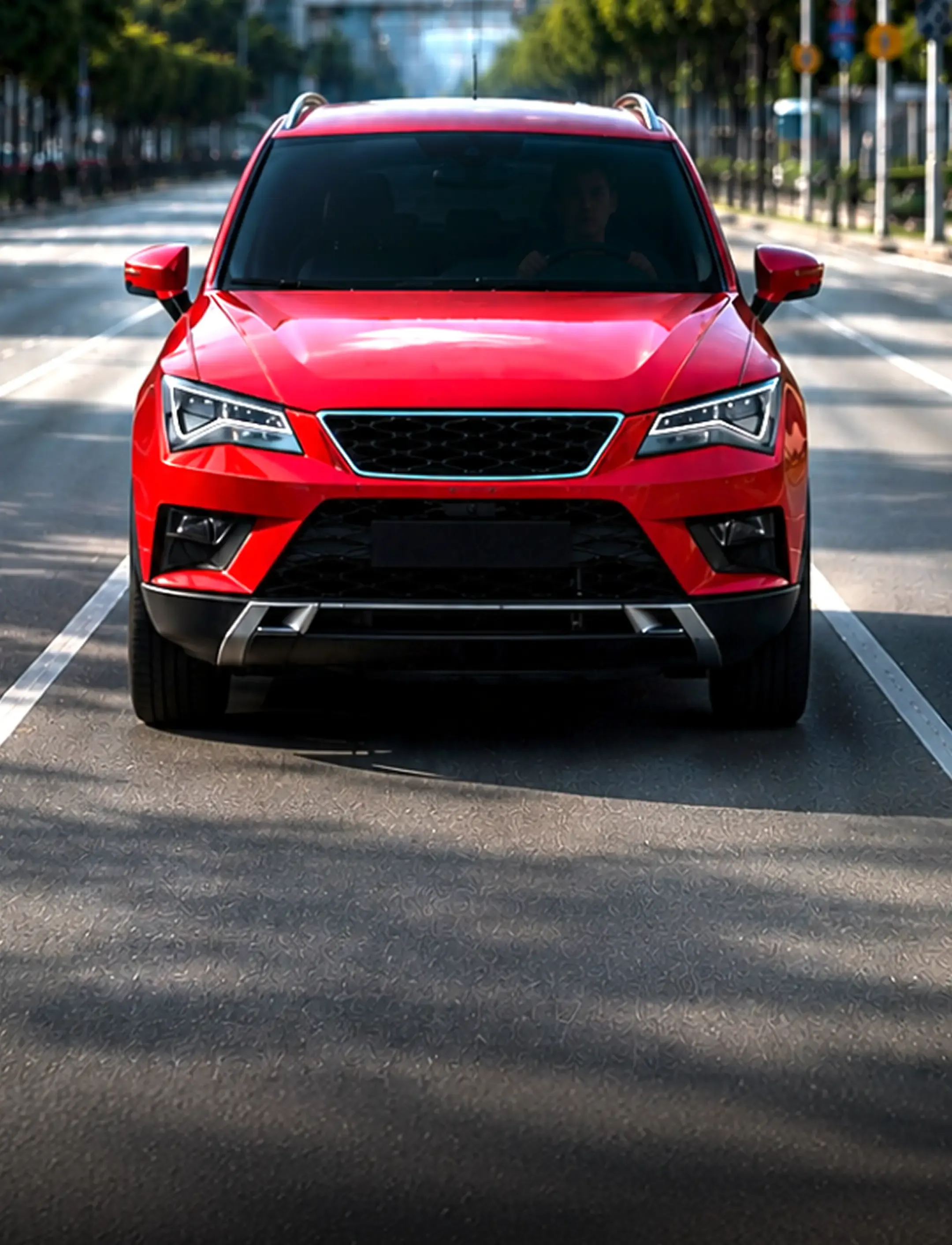 A red SUV driving on a tree-lined city road.
